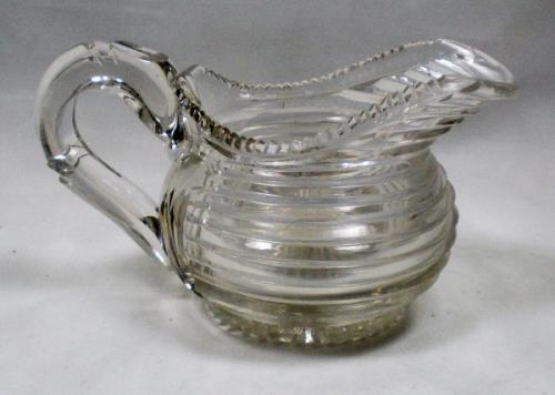 A crystal glass step cut cream jug English c.1820