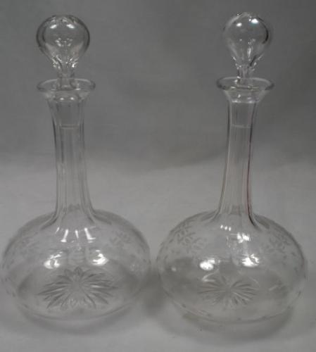 A pair of crystal glass shaft and globe decanters engraved with stars English c.1870