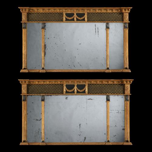 The triple mirrored plates are contained within giltwood framing, and each flanked by pharaonic herms. The upper section has ebonised tracery, with a central tablet with giltwood drapery and the reserve with typical English ‘pearl’ decoration.
