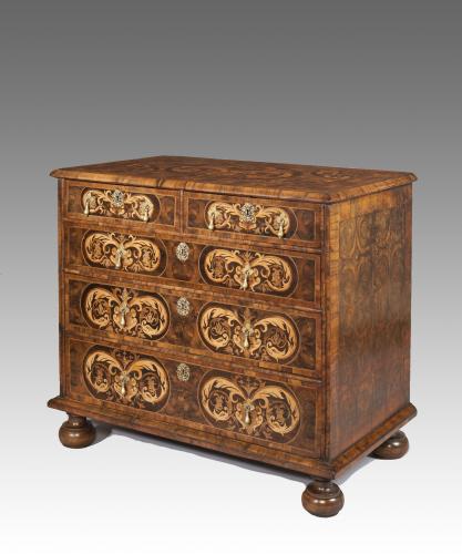 A William and Mary oyster veneered chest of drawers with marquetry inlay.