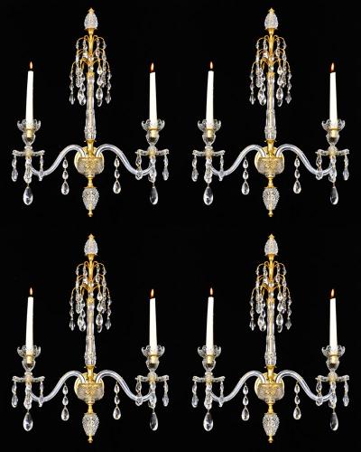 A fine set of four ormolu-mounted cut-glass two-light wall-lights in Adam style