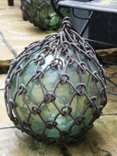One of a number of early-20th century, glass & rope, fishing floats