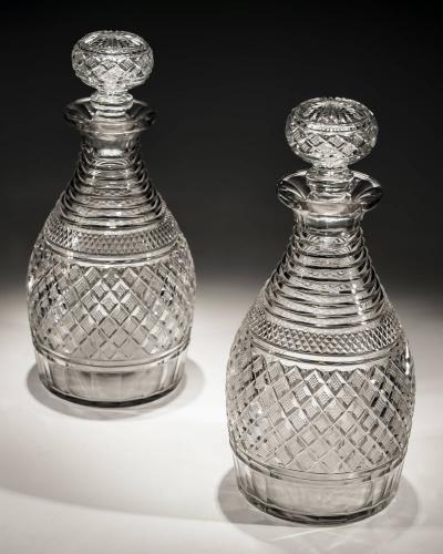 A pair of step and strawberry diamond cut Regency decanters