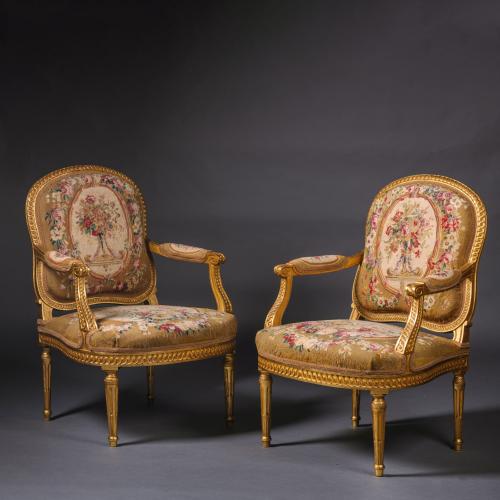 A Pair of Louis XVI Style Giltwood and Tapestry Fauteuils. France, Circa 1870. Adrian Alan Ltd