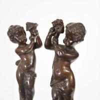 A pair of bronzed cast iron Renaissance style Italian andirons
