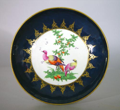 First Period Worcester Porcelain Blue-Ground Exotic Bird-decorated Cake Plate,  Circa 1770.