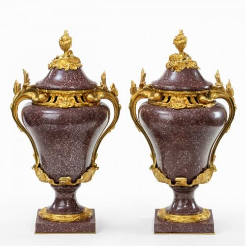 A pair of Egyptian Royal porphyry urns and covers