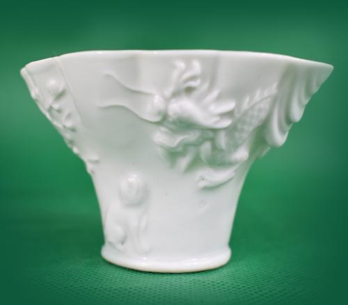 Blanc-de-chine libation cup depicting a tiger, dragon and a deer 