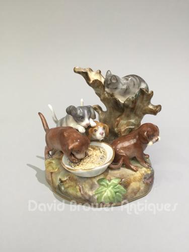 German Meissen porcelain group of feeding puppies and a cat, Circa 1880