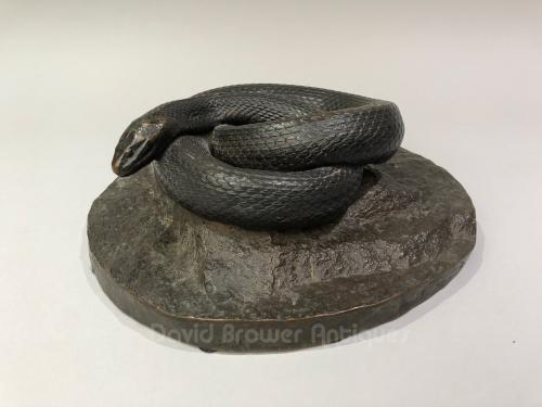 American bronze sculpture of a snake coiled upon a rock, dated and inscribed J.Munk, Reed and Barton