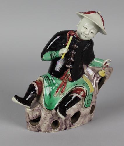 A Rare Chinese Famille-Verte Biscuit Figure of a Reclining Gentleman, Qing Dynasty, Kangxi Period