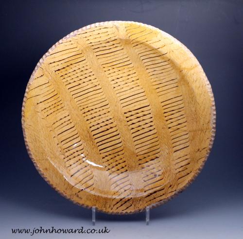Slipware charger large circular form with elaborate comb decoration early 18th century England