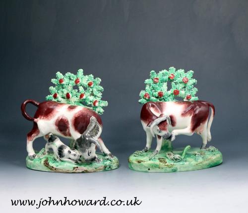 Staffordshire pottery pearlware bocage figures of a cow and bull early 19th century
