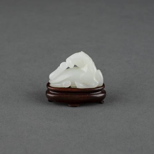 Chinese white jade carving of a recumbent horse, circa 1800
