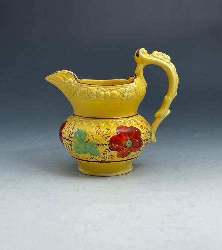 Canary Yellow pottery pitcher with bright enamel colors early 19th century