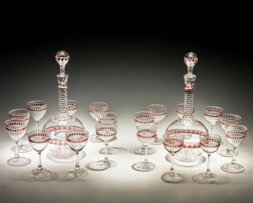 A pair of Victorian red flashed globe decanters with matching glasses
