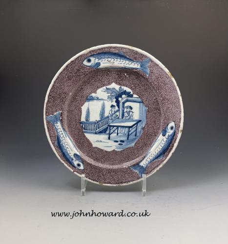 English delftware pottery plate manganese ground the border with three fishes. Mid 18th century