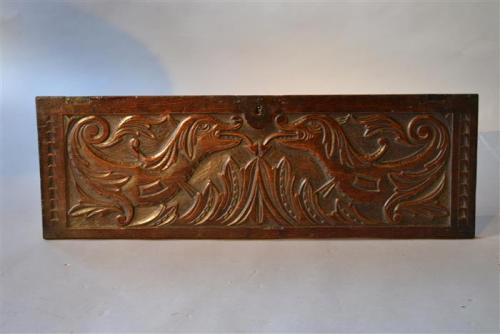 A Charles II oak coffer front depicting dragons