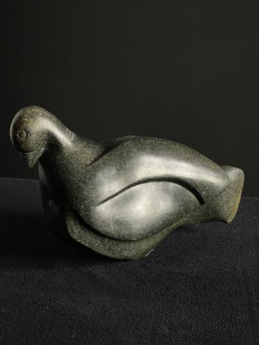 A modern springstone sculpture of a pigeon by Francis Simone