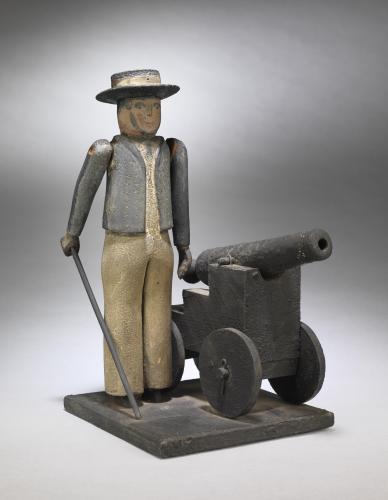 Engaging Primitive Folk Art Sculpture of a Sailor  Wearing a Boater and a Blue Tunic, Standing Beside a Cannon Carved Wood Retaining Original Paint Surface  British, c.1880