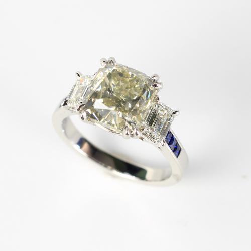 A cushion cut diamond and sapphire ring
