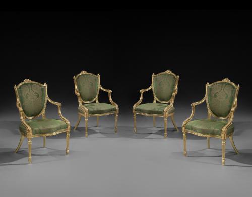 A set of four George III giltwood armchairs