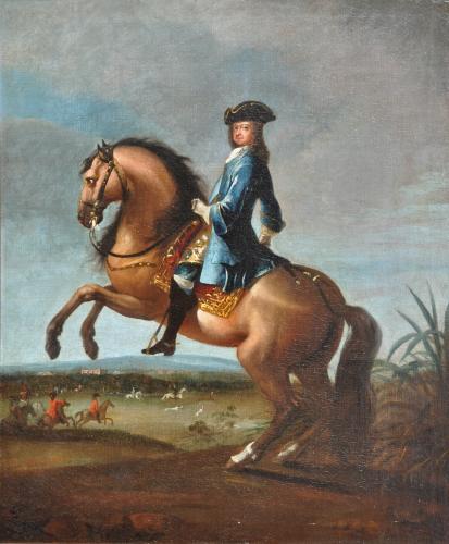 equestrian portrait of a gentleman in a blue coat, brocade waistcoat and tricorn hat on a rearing charger, a view to a hunt and a country house beyond
